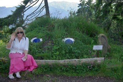 Wednesday 23  June, 2010  On our return, Jenni spots the earthen-works statue of a head. She is waving to Remmi who is always in her thoughts. : 2006-06-23 Bavarian Alps