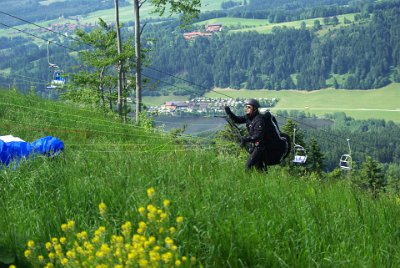 Wednesday 23  June, 2010  On our return to the Blombergbahn, we see a para-glider pilot wrestling with his kit. : 2006-06-23 Bavarian Alps