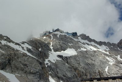 Monday 28  June, 2010  When we look back up the hill to the Zugspitzbahn, the cloud has moved in. Just as quickly, it moves out. And in again. : 2010-06-28 sugspitze