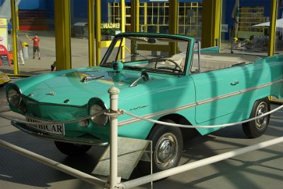 Wednesday 14 July, 2010   While Jenni buys the tickets, I take a quick look at the Amphicar in the foyer. The Amphicar is a German amphibious automobile and was the first mass-produced  vehicle of its kind. It went on sale in 1961 and, compared to most boats or cars, its performance was modest. By 1965 when production ceased,  only 4000 had been produced and it is now an extremely valuable collector's car. : 2010-07-13 Claus