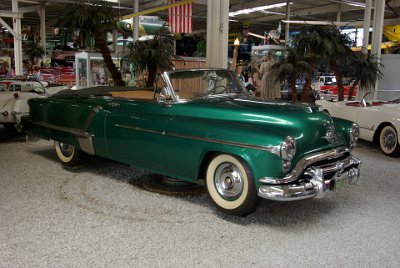 Wednesday 14 July, 2010  1953 Oldsmobile Rocket 98   In 1953 the "Rocket Ninety Eight" was the longest motor car on American roads and it had the most powerful motor. This car's standard equipment included bumper guards, electric clock, lined trunk, dual horns, cigarette lighter, chrome moldings, twin interior sun visors, rear seat robe rails, special rear stainless steel trim, chrome window ventiplanes, windshield washer, and a deluxe steering wheel with horn ring. A padded safety dash also became standard and for the first time air conditioning was an option. : 2010-07-13 Claus