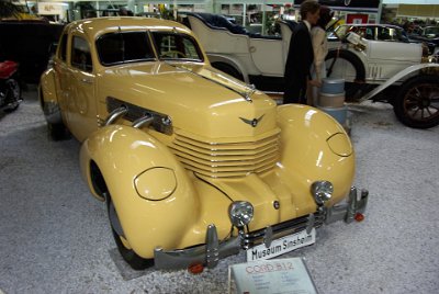 Wednesday 14 July, 2010  1937 Cord 812   The Cord was the first American front wheel drive car with independent front suspension. It was powered by a 4,739 cc  Lycoming V8. The semi-automatic four-speed transmission extended in front of the engine which allowed the designers to dispense with the driveshaft and transmission tunnel. As a result, the new car was so low it required no running boards. : 2010-07-13 Claus