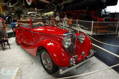 Wednesday 14 July, 2010  1938 Jaguar SS  The Jaguar SS  on display was built in 1938, fitted with a  90 hp, 2.5 litre six cylinder engine, and it was a true 100 mph sports car.  The SS was built by SS Cars Ltd of Coventry, England  founded in 1922 as the Swallow Sidecar Company.   In 1936 the name  Jaguar was given to a new saloon car and from then on to all the cars that SS produced.  Following World War II, because of the connotations then attached to the initials SS, the company was renamed Jaguar. : 2010-07-13 Claus