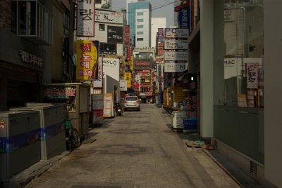 Thursday 10 June, 2010  As we head towards the Tapgol Park, we walk through some of the smaller streets. These are usually a combination of store fronts and garbage bins. : Seoul