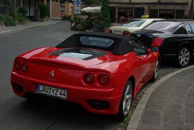 Monday 12 July, 2010 &nbsp;  On leaving the restaurant we spotted this magnificent Ferrari. A Bentley was parked in front of it. The Mercedes-Benz taxi looks very ordinary by comparison. The licence plate contains a Bavarian registration seal and a colour coded safety sticker. The LAU means that the car is registered in  Lauf an der Pegnitz & Nürnberger Land.  Lauf an der Pegnitz is a municipality near Nuremberg and it is the capital of  Nürnberger Land. : 2010-07-12 Nurnberg