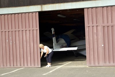 Tuesday 13 July, 2010 &nbsp;  The Aero club is called the Aero-Club Fürth e.V. It was founded in 1950 and the airfield was built in 1961. Gisela opens the doors to the second hangar to gain access to the control tower. : 2010-07-13 Neurnberg