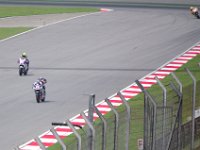 Friday 19 October 2012  Valentino Rossi exits turn 13 while Randy de Puniet (14) looks behind. The other bike (77) is ridden by James Elilison on a CRT bike (Claiming Rule Team) : MotoGPMalaysiq