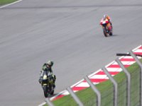 Friday 19 October 2012  Cal Crutchlow, England (35) rides the second of two Yamaha M1 satellite bikes.  He looks behind to get out of the way of Dani Pedrosa, Spain (26) on a factory team Honda RC211V. : MotoGPMalaysiq