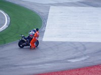 Saturday 20 October 2012  A marshall assists him to get his bike upright. : MotoGPMalaysiq