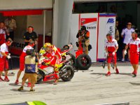 Sunday 21 October 2012   One of Rossi's mechanics rushes forward with a jack to lift the rear wheel off the ground. A spare wheel sits waiting with a tyre warmer on.  Looks like a tyre change coming up. : MotoGPMalaysiq