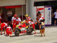 Sunday 21 October 2012   Rossi walks past his spare bike while a mechanic undoes the axle nut on his first bike. : MotoGPMalaysiq