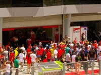 Sunday 21 October 2012   The pit walk crowd clusters around Rossi's garage.  Look at all the red Rossi Ducati shirts & caps  and yellow Rossi shirts & caps. : MotoGPMalaysiq