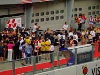 Sunday 21 October 2012   A large crowd welcomes Fahmi Khairruddin into parc ferme. You can just make out the Malaysian flag on Fahmi's helmet. : MotoGPMalaysiq