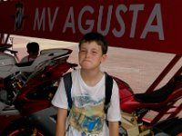 Friday 11 October 2013  We now walk to the main grandstand and along the way Sam poses in front of an MV Agusta : Sepang