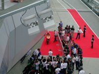 Saturday 12 October 2013 - Qualifying day  His crew stand around to welcome him. : Sepang