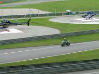 Sunday 13 October 2013 - Race day  Two emergency helicopters stand by in readiness as Rossi completes morning warmup : Sepang