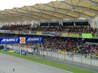 Sunday 13 October 2013 - Race day  Dean takes a picture of Sam and I. I'm in the salmon-coloured shirt leaning against the last column on the left. : Sepang