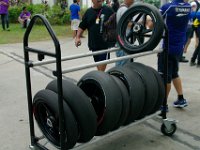 Sunday 13 October 2013 - Race day  They go through masses of tyres every weekend. The white stripe indicates that these tyres are the softer of the two options. The front wheel in the top rack is the harder. : Sepang