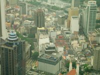 Thursday 10 October 2013  St John's Cathedral is the Christian church in the foreground. The tall domed building next to it is the  Menara Olympia, a 33 storey office building. Part of KL's Light Rail Transit (LRT) cuts through the centre of the picture. The Menara Maybank HQ - 50 floors - is to the left. The Klang River, one of the two rivers that give KL its name is at the top. : Sepang