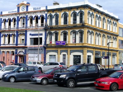 Day 2 - 40th Anniversary trip to NZ  The basic buildings are fabulous and with a coat of paint, in heritage colours perhaps, the place would look spectacular.  Squatters occupy this derelict, once magnificent, building on the east side of town near Victoria Park. A girl squatter sits in the window on the first floor.