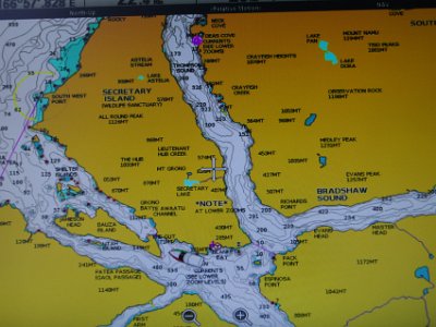 Day 5 - 40th Anniversary trip to NZ  We motor up the southern side of Secretary Island which is a wildlife sanctuary.  I take this picture of the onboard navigation system.  Our boat can be seen approaching Bauza Island. Secretary Island's western side faces the Tasman Sea and the triangular shaped island provides two passages to Doubtful Sound.