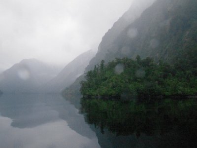 Day 5 - 40th Anniversary trip to NZ  After a while I can hear a waterfall running and for a short time, the sound of small waves hitting the shore line.  It is wet on deck and drops of water running off the boat’s canopy fall like thunder on to the metal deck.  It is a magical experience.