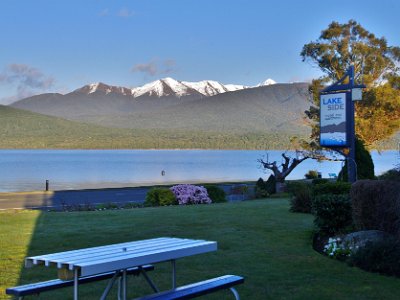 Day 6 - 40th Anniversary trip to NZ  It is a beautiful, clear sunny day when we awaken this morning.  The sun, rising behind us in the east, casts a sharp shadow. The sky is clear in the Fiordland National Park opposite and we see snow on mountain tops that were previously hidden behind the clouds. Glorious.