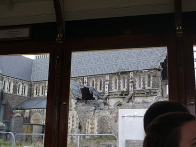 Day 8 - 40th Anniversary trip to NZ -  Jenni explores the city area   The tram continues around the Christchurch Cathedral to its northern side. The earthquake destroyed the cathedral's spire, part of its tower, and severely damaged the structure of the remaining building.