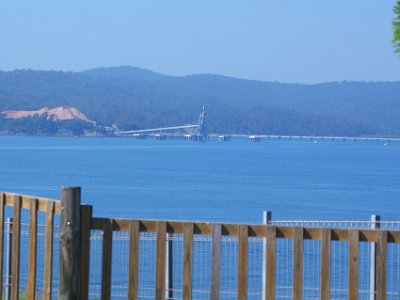 TEL 1843-1     MONDAY Eden Rotary Park and Lookout  That white mountain on the left side of the picture is wood chips, 3.5 kms away. The chips are produced on site here.   The Conveyor is for loading the chips onto ships for processing in China and Japan. A small amount is processed in Australia for local needs.