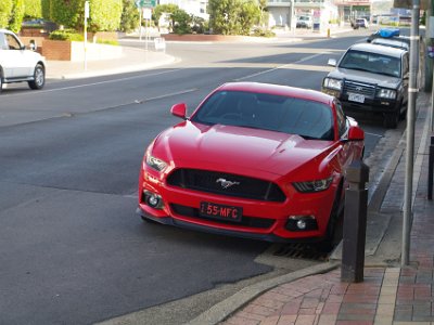 SUNDAY MORNING  Merimbula for breakfast  We find a likely looking cafe, order breakfast and sit at the tables outside. Right next to us is this late model Mustang 5.0 litre hardtop. I'd even have the colour as well.