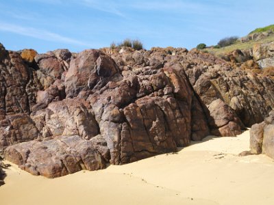 SUNDAY Bournda Beach  These weathered rocks are interesting.  Even though the cracks are vertical, the sedimentary layers are horizontal.