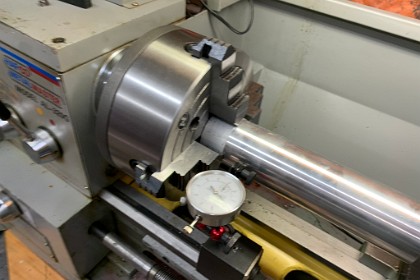 November 2021  I put the 4-jaw chuck in the lathe and retrieve my lump of 60mm alloy. I indicate it to set the workpiece centrally in the lathe's jaws. <div style="Font-size:5.0pt"