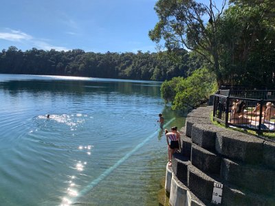 A maar is a broad, low-relief volcanic crater caused by a volcanic eruption in which both gases and steam from groundwater are expelled.  A maar characteristically fills with water to form a relatively shallow crater lake.