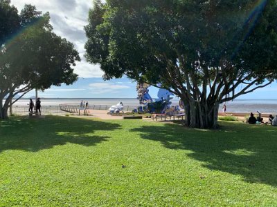 An aboriginal family enjoys a picnic on the right and two aboriginal girls exit left. I put this picture in because seeing our first nations people is a rare experience for me living in Sydney.