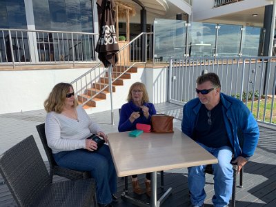 The weather is  so nice, we sit outside in the sunshine to continue our catch-up and watch the people surfing and playing on the beach.