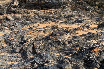 Sunday 29 May, 2022 - Myrtle Beach  Meanwhile, Jenni at the Southern end of the beach, takes this amazing picture of the rocks on the headland. Is this schist I wonder? It's clearly been tortured by the firey heat of hell.