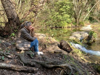 Sunday, 5 March 2023 Sussie contemplating by La Brague.  This area is part of a national forest.