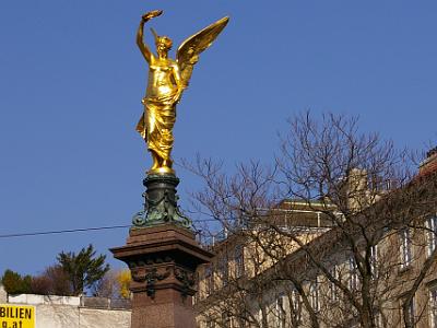 Saturday 8 April, 2006  The statue is topped with an angel decorated in brilliant gold. Behind the monument is the Beethoven Pasqualati House where Beethoven lived for about 8 years.  Pasqualati was a patron of Beethoven's and the house is now a small museum.  It apparently  has very few  of Beethoven's possessions in it and it seems to be more of a small apartment than a museum.