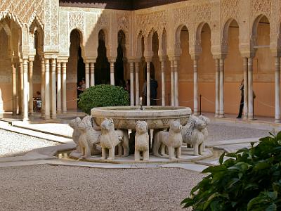 Sunday 2 April, 2006  The Court of the Lions (Patio de los Leones‎) is the main court of the Palace of the Lions. At  the other end of the court is the Hall of the Kings. Behind us is the Hall of the Mocarabes (mocarabe: design of interlaced prisms).