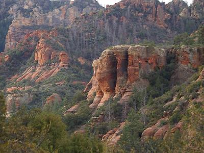 Friday 10 March, 2006  Nearing the township of Sedona. Sedona is surrounded by red cliffs like these.