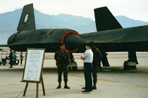 Armed guards mind the plane. The Skunk Works logo is on the plane.